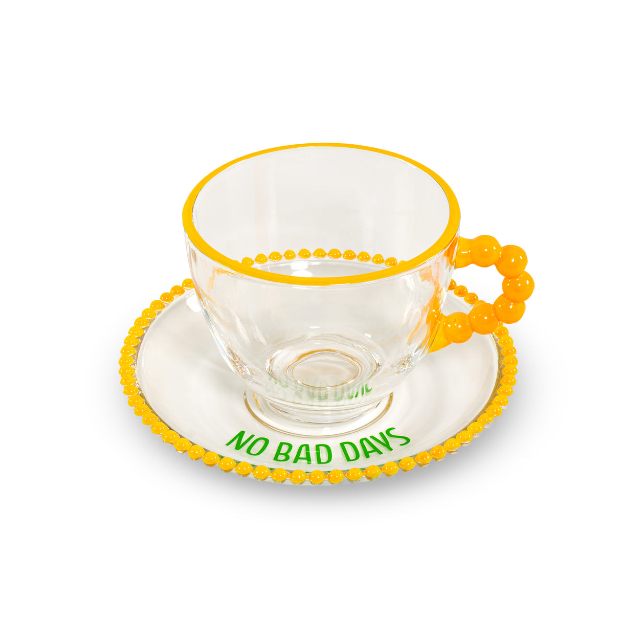 Lot de 2 tasses en verre WD LifeStyle de 230 ml avec soucoupes, décorées avec les inscriptions « Que de la bonne énergie » et « Pas de mauvais jours », jaune et vert.
